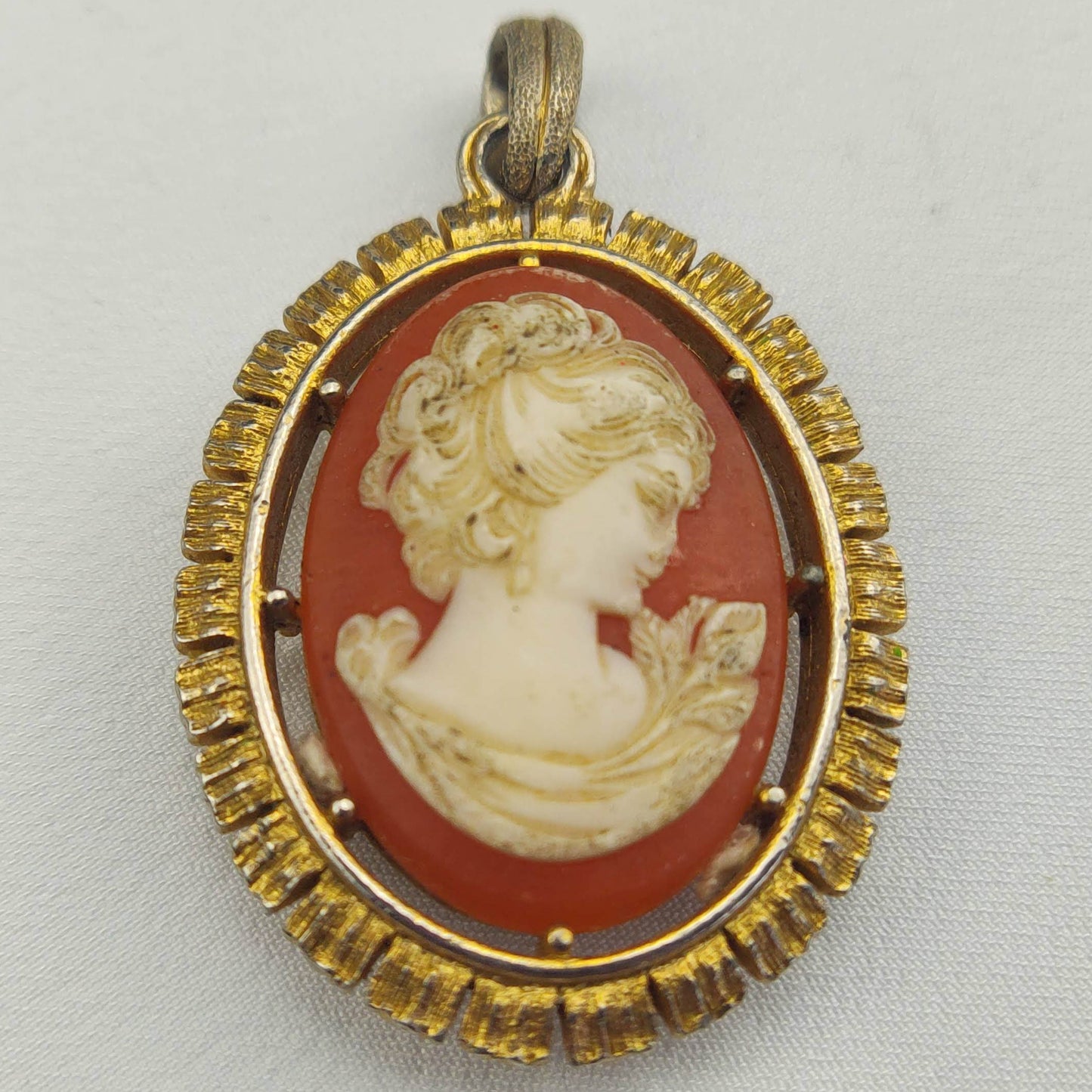 1950's White on Red Bakelite Cameo Pendant in a Gold Tone Frame