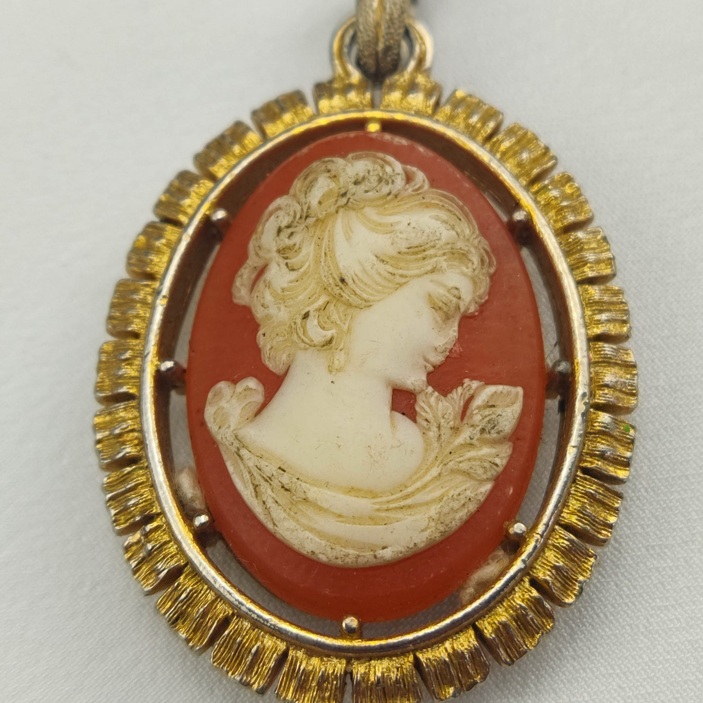 1950's White on Red Bakelite Cameo Pendant in a Gold Tone Frame