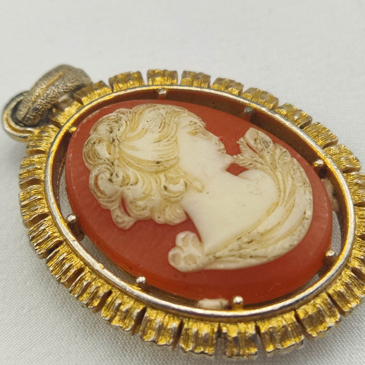 1950's White on Red Bakelite Cameo Pendant in a Gold Tone Frame