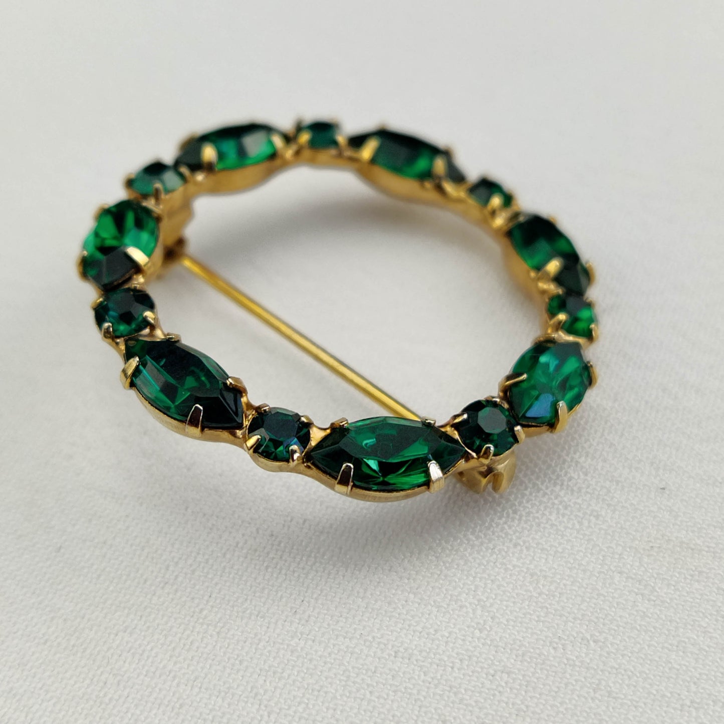 1950's Green Rhinestone Circle Pin with a Gold Tone Metal Backing