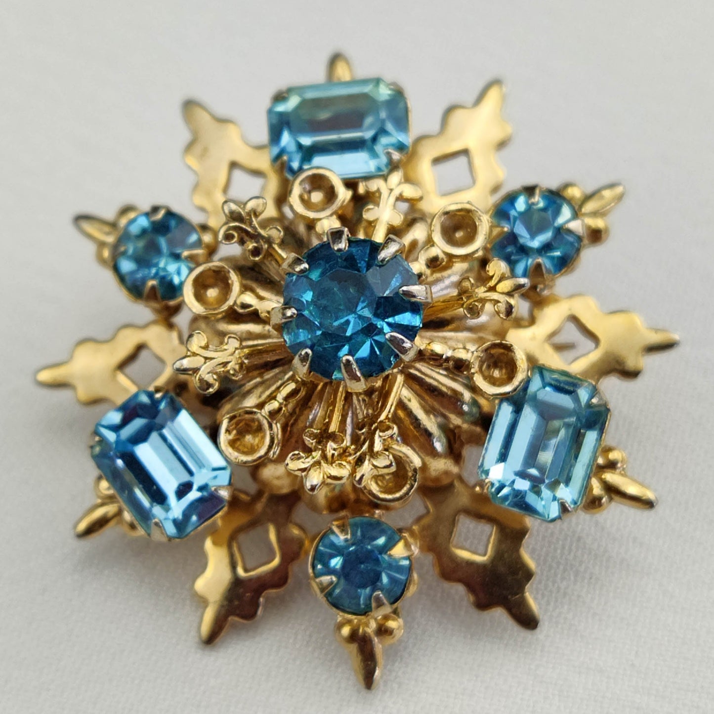 1950's Gold Tone Filigree Blue Rhinestone Star Pin