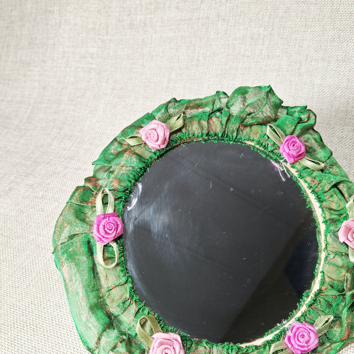 Vintage Hand Mirror: Unique and Hand Made with Fabric Roses on a Green Background