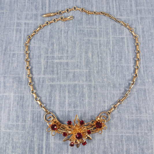 1970s Vintage Necklace with Gold Tone Winged Metal and Red Rhinestones