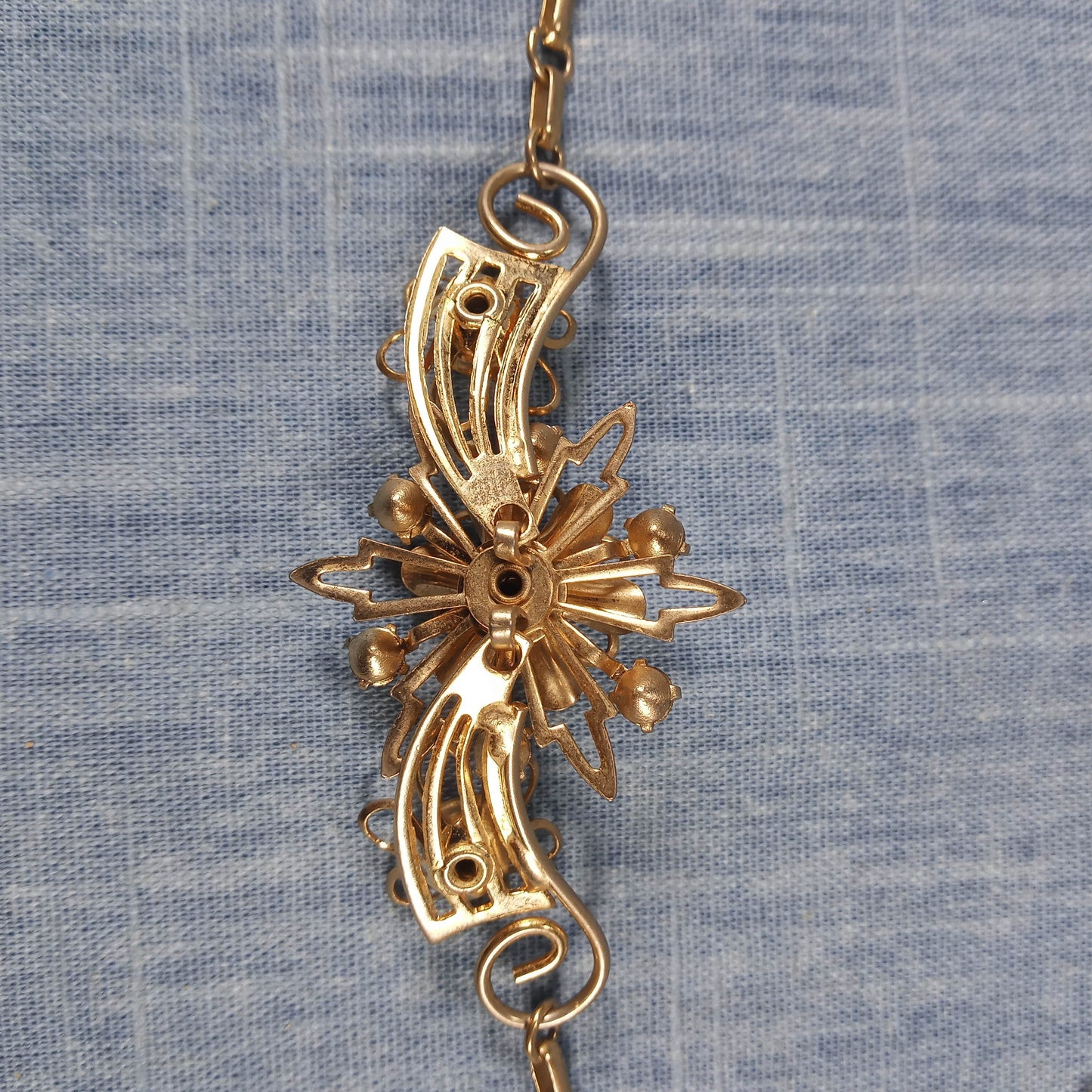 1970s Vintage Necklace with Gold Tone Winged Metal and Red Rhinestones